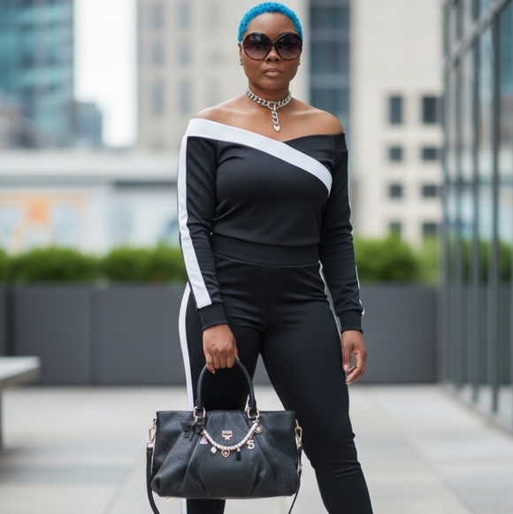 MCM Handbags - MCM Black Leather Handbag with Gold Accents